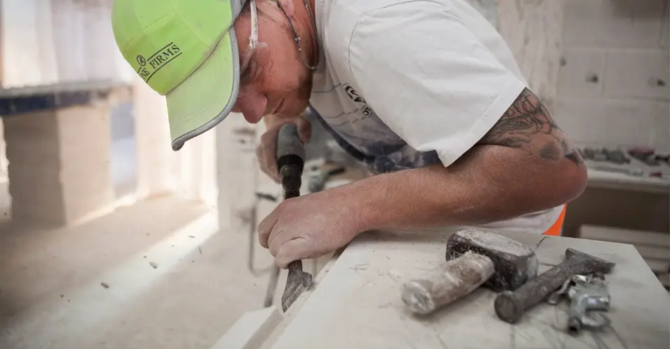 Masons working our natural Portland limestone