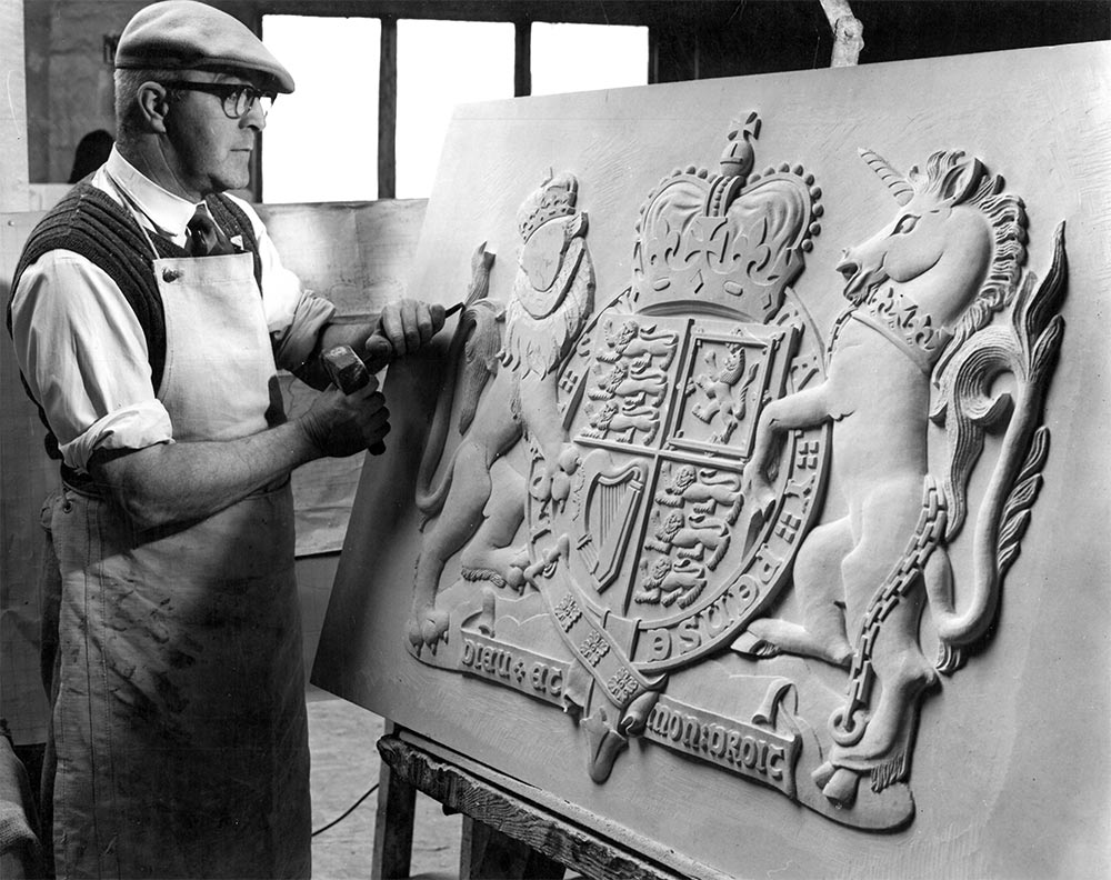 Lead carver Harry Garland finishing Portland stone coat of arms.